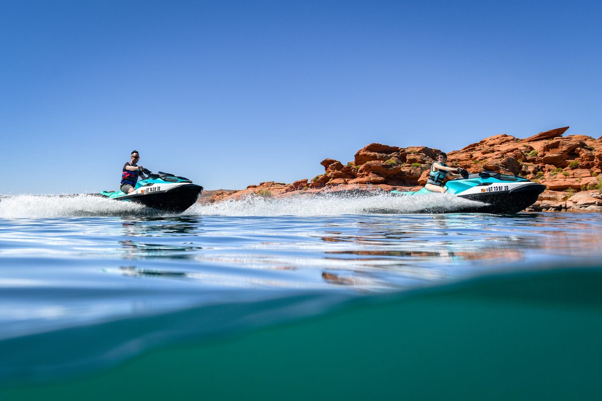 man and woman jet skiing on Sand Hollow Reservoir.