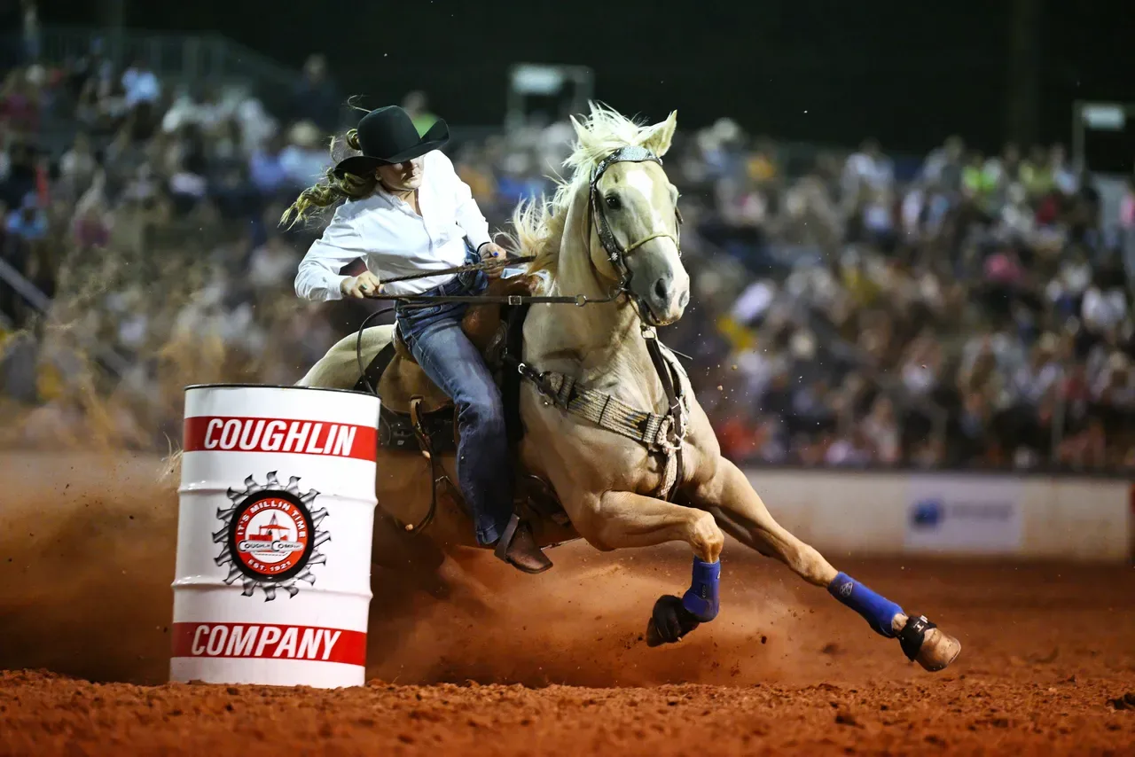 Dixie Round Up Rodeo, female rider barrel racing. 