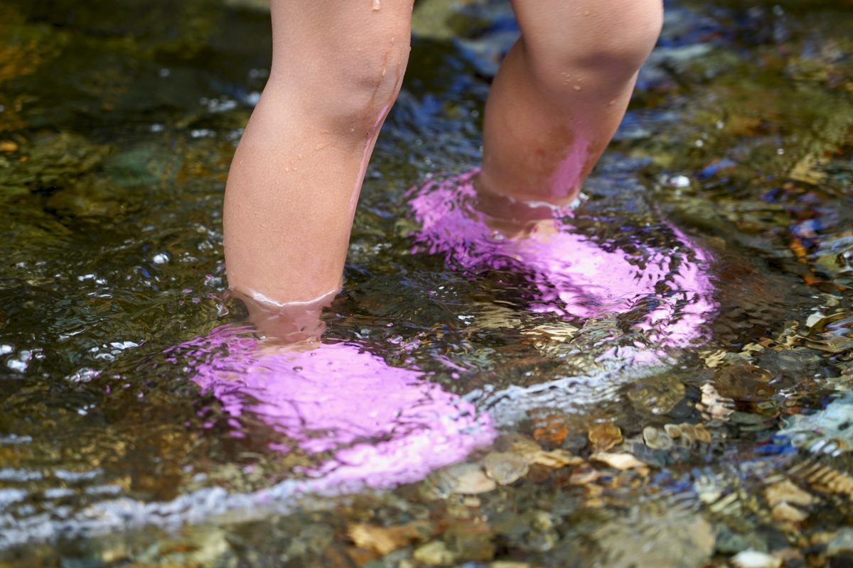 Child's feet  in a river