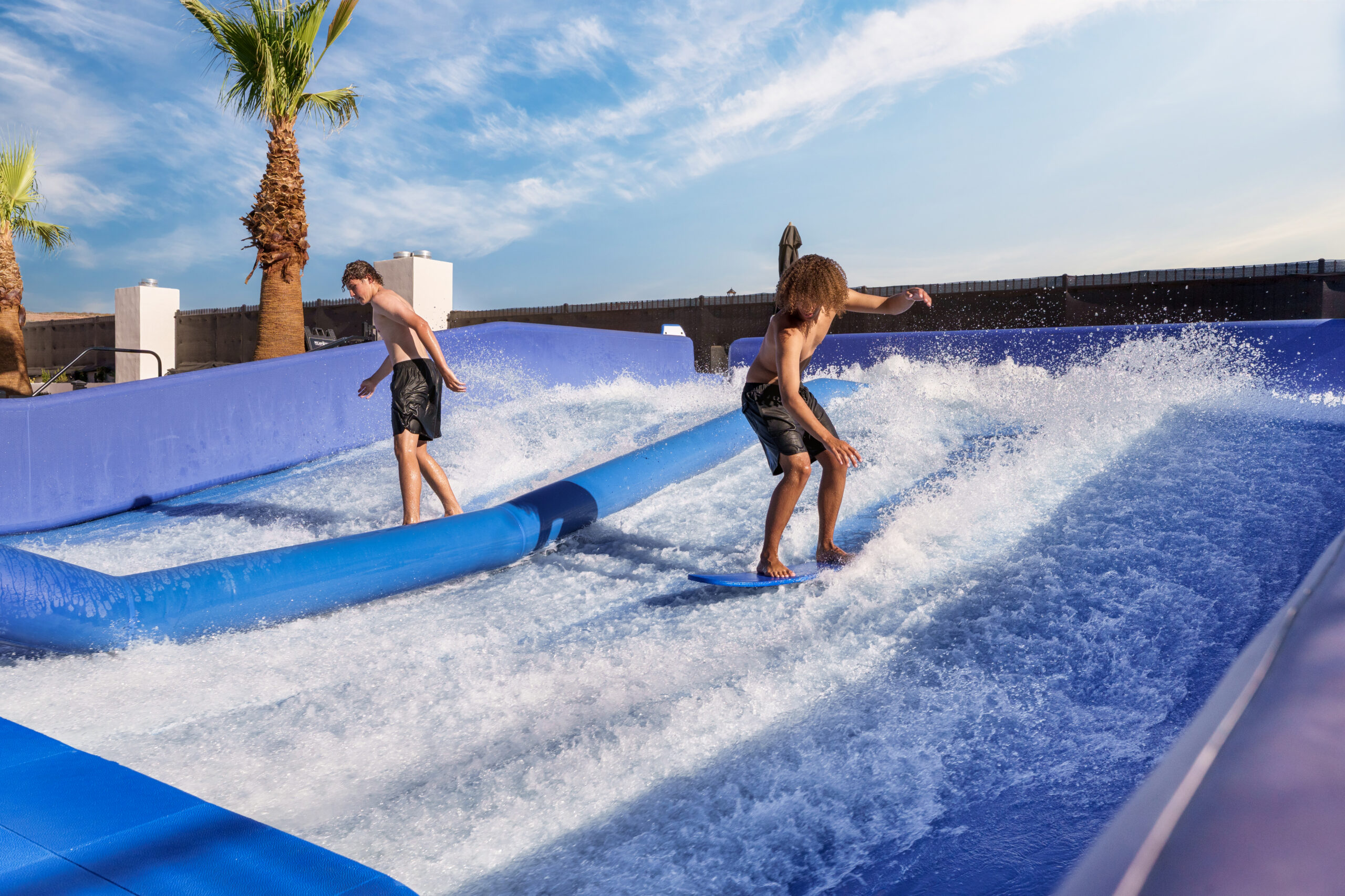 Kids riding a wave rider at Pecan Valley Resort